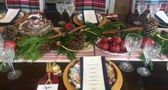 the table is set for christmas dinner with pine cones