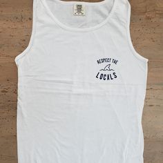 "Comfort colors tank with our popular \"Respect the Locals\" shark graphic is perfect for all of our summer beach days." White Beachy Tank Top, Beachy White Sleeveless Tank Top, Beach Letter Print Tank Top, Beach Sleeveless Tank Top With Letter Print, Basic Tank Top For Summer Streetwear, Sleeveless Letter Print Tank Top For Beach, Beach Season Tank Top With Letter Print, Summer Crew Neck Tank Top With Graphic Print, Letter Print Tank Top For Beach Season