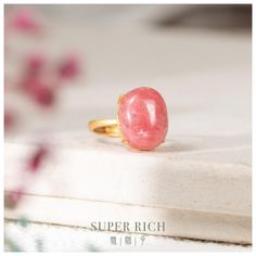 Discover the timeless elegance of our Vintage S925 Silver Rhodochrosite Ring, set in a beautifully detailed yellow gold plated design. This ring features a high-quality oval-shaped cabochon rhodochrosite stone, known for its stunning pink hue and calming properties. Item Details: *Item No.: C-R-007 *Material: Yellow Gold Plated S925 Silver, Rhodochrosite *Rhodochrosite Size: 16.5mm (L) x 12.8mm (W) x 7.6mm (H) *Cut: Oval-shaped Cabochon *Setting: Vintage S925 Silver *Ring Size: Adjustable Join our circle of kindness:  with every purchase, we invite you to leave a review. For each one, we'll make a charitable donation. You will get the exact item shown in the photos DELIVERY:  Free standard shipping from Hong Kong with tracking number QC:  All products will be fully checked by our qualified Elegant Oval Cabochon Rings With Natural Stones, Elegant Oval Ruby Ring With Natural Stones, Oval Cabochon Crystal Ring As Gift, Pink Cabochon Ruby Ring Gift, Oval Cabochon Ruby Ring Gift, Pink Oval Opal Ring For Gift, Pink Oval Cabochon Rings For Gift, Pink Oval Cabochon Rings As Gift, Gift Ruby Ring With Natural Stones