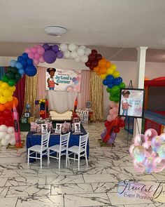 an indoor party with balloons and tables set up for a children's birthday celebration