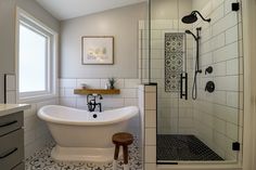 a white bath tub sitting next to a walk in shower