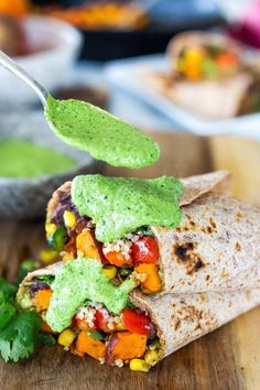 a tortilla filled with vegetables and guacamole