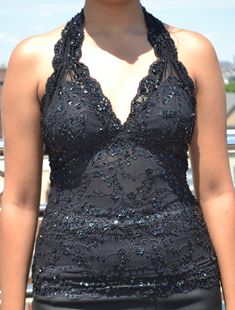 "Gorgeous sleeveless halter stretch lace waist length top in black color hand-decorated with matching color beads and sequins, very nice wear for special occasions. The neck strap is also beaded but the back part is plain. 1. Available in four sizes (XS, S, M, and L) 2. Made from stretch lace, easily expandable on all sides. 3. Three rows of hooks and eyes closure at the back for better fitting (see pic). 4. The bust area has an inner cotton lining to block transparency. 5. Items located in the Embellished Sleeveless Halter Top For Party, Party Season Sequined Halter Top, Sequined Backless Halter Top For Party Season, Sequin Sleeveless Halter Top For Evening, Sequined Halter Top For Party, Sequin Halter Top For Evening Wear, Sequin Backless Halter Top For Night Out, Embellished Halter Top For Party, Sleeveless Party Halter Top With Sequins