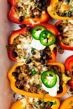 stuffed bell peppers with cheese and black beans in a white casserole dish, ready to be eaten