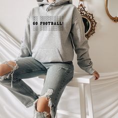 "Football Sweatshirt, Team Sweatshirt, Game Day Sweatshirt, Football Mama Sweatshirt, Unisex Sweatshirt, Football Hoodie *PLEASE READ ORDERING INSTRUCTIONS BEFORE PURCHASING* \"CUSTOMIZATION\" If you are looking for a specific shirt style, design or color not offered in my store, please let me know. \"RETURNS / EXCHANGES\" Unfortunately, due to the customization of the shirts we are unable to accept returns or exchanges on merchandise. In case of dispute, the buyer pays the return shipping fee. Team Sweatshirts, Mama Hoodie, Lady Cat, Hoodie Aesthetic, Football Sweatshirt, Shirt Printing, Mama Sweatshirt, Bridesmaids Personalized, Custom Sweatshirts