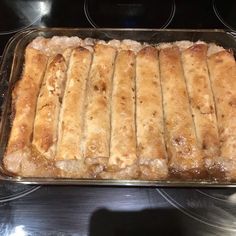 a pan filled with food sitting on top of a stove