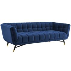 a blue velvet sofa with gold legs