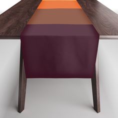 the table is made out of wood and has an orange strip on top of it