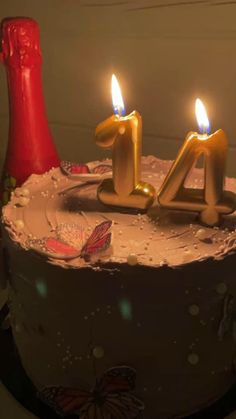 a birthday cake with lit candles on it and the number forty four in gold letters