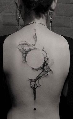 the back of a woman's neck with a tattoo design on her upper part