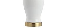 a white vase sitting on top of a gold base