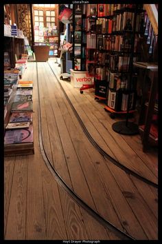 there are many books on the shelves in this store, and one is upside down