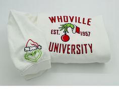 Gorgeous Embroidered Whoville Grinch season Sweatshirt. Great Gift maker!  Please size up if you want a more baggy look! ---------- Product ---------- * 75% cotton, 25% poly, some sweatshirts are 50%cotton 50% poly * Colors may seem different on the computer screen, or in the lighting in which the picture was taken. * Each item is sold separately. * Double-needle stitching throughout * Seamless collar * We use direct to film printing method * Taped shoulder-to-shoulder ----CARE INSTRUCTIONS----- Christmas White Embroidered Tops, White T-shirt With Embroidered Text For Winter, White Tops With Custom Embroidery For Christmas, White Winter Top With Embroidered Text, White Embroidered Text Top For Winter, White Christmas Tops With Embroidered Graphics, White Embroidered Top For Winter, White Embroidered Winter Tops, Winter White Embroidered Tops