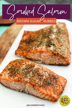 two salmon fillets on a cutting board with seasoning sprinkled on them