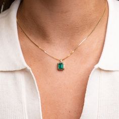 Our 14k Emerald Bezel Necklace features a lustrous and stunning genuine emerald forged in 14k yellow gold. We love the enhanced statement that this setting makes with its thick layer of gold perfectly bordering the natural emerald cut stone. 14k Solid Gold and Genuine Emerald Approximately 1.5 CTW Available as a pendant only, or with our 14k Cable Chain or Box Chain Available in lengths 16", 18", and 20" Due to the handmade nature of this necklace, please allow 1 - 3 weeks for processing. Bezel Necklace, Solid Gold Chains, Zambian Emerald, Natural Emerald, Box Chain, Chain Pendants, Fast Fashion, Emerald Cut, Cable Chain