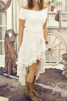 a woman in a white dress and cowboy boots