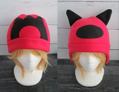 two pictures of a wig with a red and black cat hat on top of it