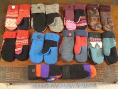 many pairs of mittens are lined up on a table