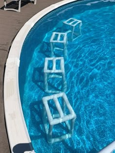 an empty swimming pool with ladders in it