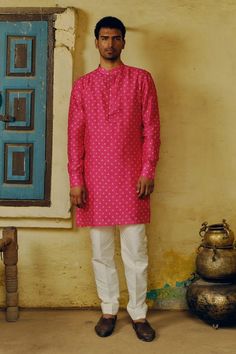 Rani pink woven straight kurta with contrasting bandhej prints and potli button detailed placket. Comes with solid contrasting white cotton silk pant. - Aza Fashions Pink Straight Kurta Bandhgala For Festivals, Pink Bandhgala Straight Kurta For Festivals, Pink Unstitched Bandhgala For Festivals, Pink Kurta With Dabka Detailing, Pink Chanderi Sherwani For Eid, Pink Bandhgala With Chikankari Embroidery, Pink Sherwani With Gota Work For Diwali, Pink Straight Kurta For Festive Occasions, Traditional Pink Bandhgala For Festivals