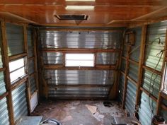 the inside of an old run down building with metal siding and windows on each side