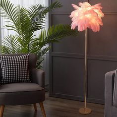 a floor lamp with a pink feather on it