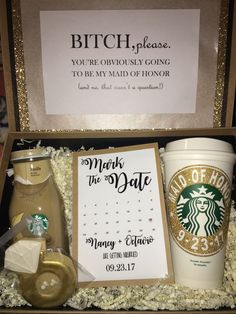 a starbucks gift box with a note, coffee cup, and other items in it