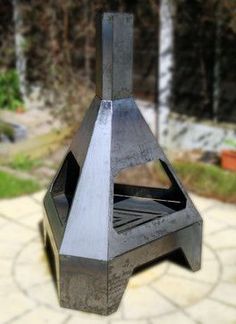 a metal object sitting on top of a stone walkway