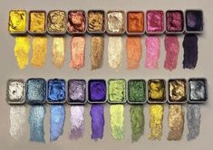 many different colors of powder in tins