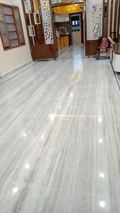 an empty room with white marble floors and walls, in the middle of a building