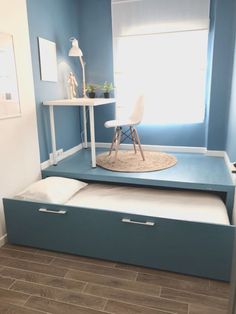 a room with blue walls and white furniture