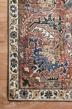 an antique persian rug on a wooden floor