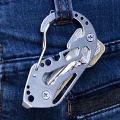 a pair of scissors is attached to the pocket of someone's jean pants with an adjustable belt