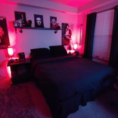 a bedroom with pink lighting and black bedding