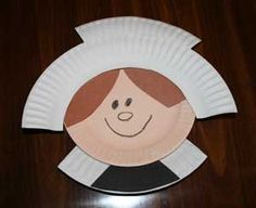 a paper plate with a woman's face on it, sitting on a table