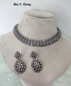 * Light weight Silver necklace Set with earrings Tikka as shown in the     pic.  * Studded with crystals and rhinestones.  * One of a Kind. *Adjustable at any neck. *No.1 to No.4 *Necklace width- 0.6 inches *Earrings length- 1.7 inches Hand Set Round Jewelry Sets For Parties, Festive Silver Jeweled Choker, Festive Silver Jewelry Sets With Jewels, Elegant Stone Work Choker Necklace, Ornate Silver Necklace With Stone Work, Ornate Party Choker Jewelry, Silver Jewelry With Jewels For Reception, Silver Choker For Reception, Festive Silver Kundan Necklace With Jewels