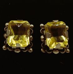 These are handcrafted 1950s Vintage large faceted rectangular (emerald shape) yellow Citrine gemstone post screw back earrings.   The stones sit upon handcrafted shaped silver barrels haloed by silver rope and circle designs. Hallmarked Silver Mexico. They are in great vintage shape for their age with a few scratches on each gemstone. See photos.  Silver has patina so I would recommend a professional polish. Silver tests 800-925   Stone has tested Citrine on Presidium Gem Tester II. 1st Citrine Measures approximately:  15.22 mm x 12.04 mm x 5.40+ mm 2nd Citrine Measures approximately:  14.86 mm x 11.97 mm 5.60+ mm Earrings weighs:  .343 ounces Free Shipping Circle Designs, Yellow Citrine, Polish Silver, Citrine Gemstone, Circle Design, Screw Back Earrings, 1950s Vintage, Citrine, Screw