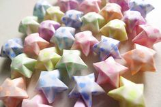 several small, multicolored origami stars on a table