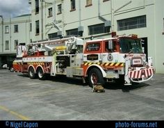 two fire trucks parked in front of a building