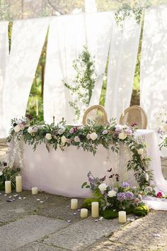 a table with flowers and candles on it