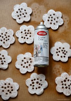 a can of krylon clear paint sitting on top of doily cutout flowers