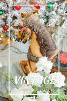 a horse figurine sitting on top of a bed next to a christmas tree