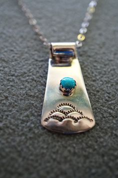 I am offering you this truly exquisite sterling silver artist signed (stamped) large classic dimensional etched curved Southwestern design pendant charm, on a fabulous necklace chain. It features a round shaped bezel set genuine turquoise stone. It measures approx. 1.5 inch, by app. 1/2 inch. The necklace chain is a very classic rolo link, and measures app. 20 inches in length. It weighs app. 7 grams. Buyer pays all shipping and handling fees. Unique Sterling Silver Turquoise Necklace Stamped 925, Etched Turquoise Sterling Silver Jewelry, Engraved Silver Turquoise Necklace In Southwestern Style, Stamped Sterling Silver Turquoise Necklace As Gift, Stamped Sterling Silver Turquoise Necklace For Gift, Engraved Turquoise Sterling Silver Necklace, Silver Engraved Turquoise Necklace As Gift, Unique Stamped Turquoise Jewelry, Southwestern Stamped Jewelry As Gift