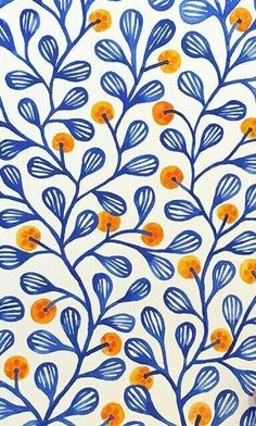 blue and orange leaves on white paper with yellow dots in the center, against a white background