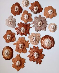 a bunch of different types of flowers and faces on a white surface with one woman's face in the middle