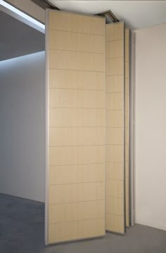 an empty room with a sliding door in the middle and light coming from it on the wall