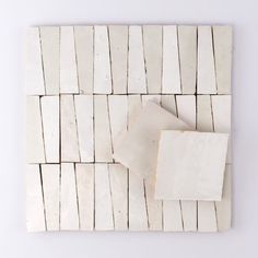 a white tile with several pieces of paper on it