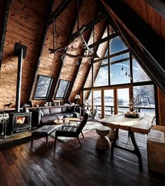 a living room filled with furniture next to a large window on top of a wooden floor