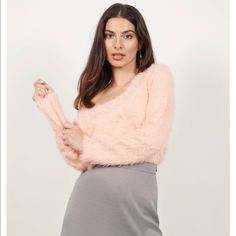 Seriously, You Just Gotta Feel It. Reach For The Out On The Town Blush Fuzzy Sweater This Winter. This Fitted Sweatshirt Features A Scoop Neckline, Tight Sleeves, And A Fuzzy Faux Fur Fabric Throughout. Perfect For Adding A Touch Of Texture To Your Outfits, Pair This Tight Fuzzy Sweater With High Waisted Trousers. Content & Care Nylon Imported Dry Flat Details & Fit Front Length: 27.5"/69.9cm Back Length: 32"/81.3cm Sleeve Length: 25.5"/64.8cm Measured In Size Small Soft/Plush Fabric Trendy Pink Sweater For Party, Pink Long Sleeve Crop Top For Winter, Feminine Pink V-neck Sweater, Casual Pink Sweater For Party, Chic Pink Crop Top For Winter, Chic Pink Crop Top For Fall, Chic Long Sleeve Pink Crop Top, Chic Pink Long Sleeve Crop Top, Pink Chic Cardigan For Party