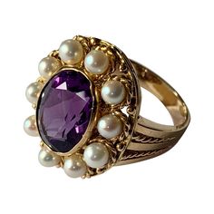 Romantic Vintage Ring in 18 K yellow Gold inspired by the Victorian era featuring an oval cut Amethyst and cultured pearls in a rope textured setting. The ring is currently size 13/53 but can be resized easily. Matching pendant/brooch available! Masterfully handcrafted piece! Authenticity and money back is guaranteed. For any enquires, please contact the seller through the message center. Victorian Luxury Amethyst Wedding Ring, Vintage Amethyst Ring Gold, Victorian Oval Pearl Ring With Gemstone, Classic Oval Multi-stone Amethyst Ring, Heirloom Multi-stone Oval Amethyst Ring, Heirloom Oval Multi-stone Amethyst Ring, Vintage Oval Pearl Ring With Center Stone, Oval Heirloom Pearl Ring, Antique Oval Amethyst Multi-stone Ring